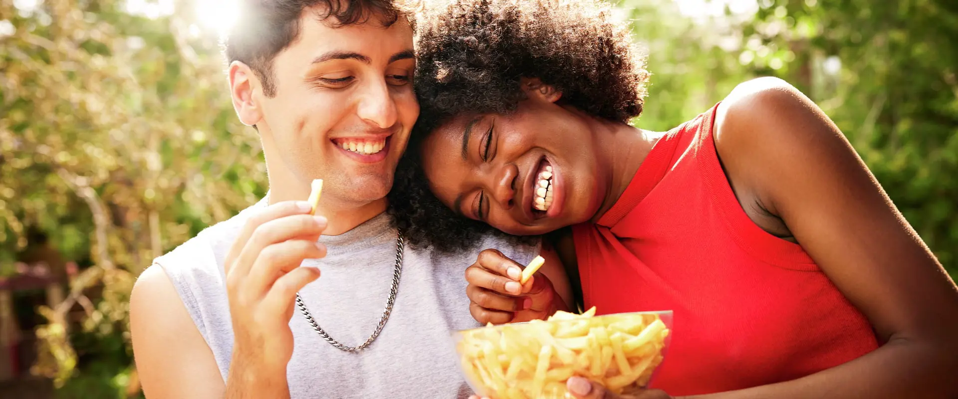 Happy family of two parents and their child laughing and focused on one another.